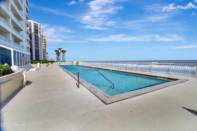 view of pool with a water view