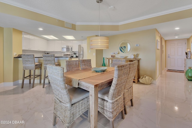 dining area with a textured ceiling and crown molding