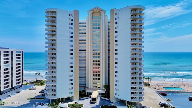 view of property with a view of the beach and a water view