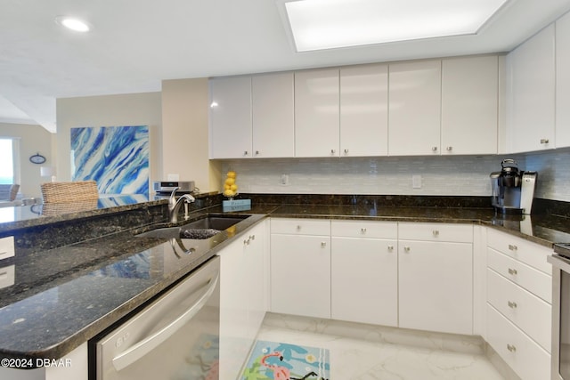 kitchen with dishwasher, white cabinets, and sink