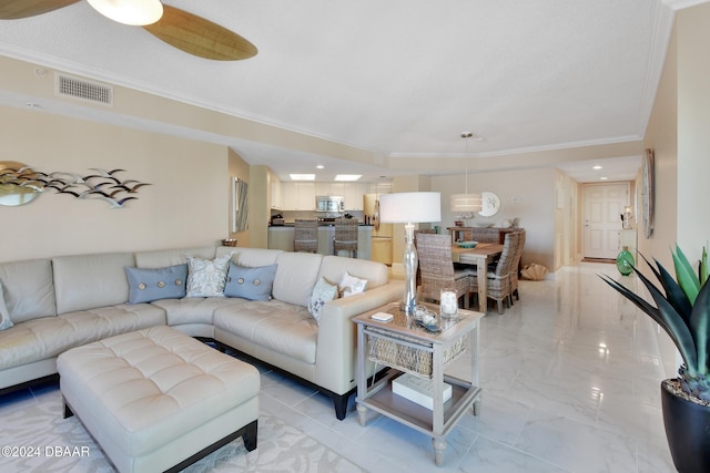 living room with ceiling fan and crown molding