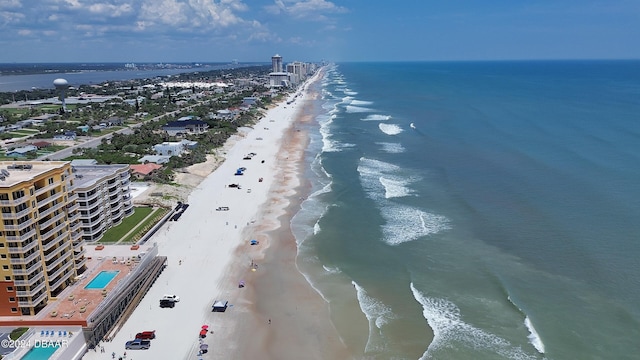 birds eye view of property with a water view and a beach view