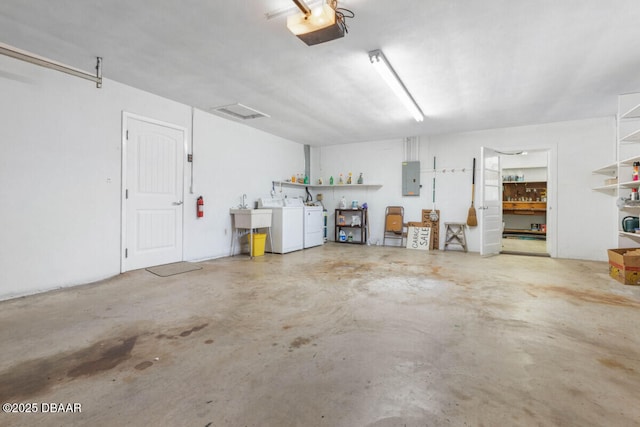 10 Juniper Dr, Ormond Beach, FL 32176 - garage featuring washing machine and clothes dryer, a garage door opener, and electric panel