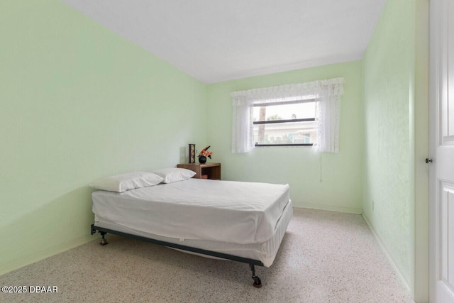 10 Juniper Dr, Ormond Beach, FL 32176 - bedroom featuring baseboards and speckle patterned floor