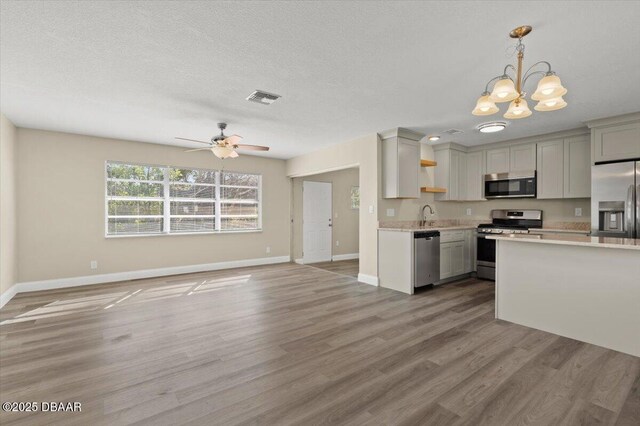 1609 Stocking St, Daytona Beach, FL 32117 - kitchen featuring open floor plan, light countertops, visible vents, light wood-style flooring, and appliances with stainless steel finishes
