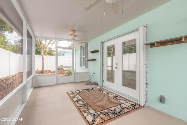 sunroom / solarium featuring ceiling fan and french doors