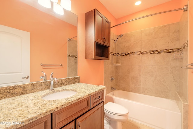 full bathroom with tile patterned floors, toilet, vanity, and tiled shower / bath combo