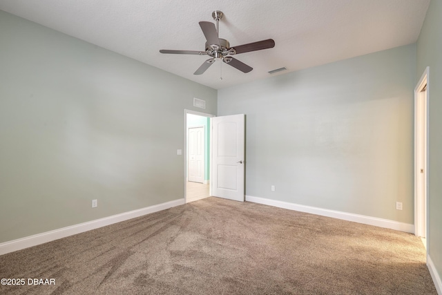 empty room with carpet floors, a textured ceiling, and ceiling fan