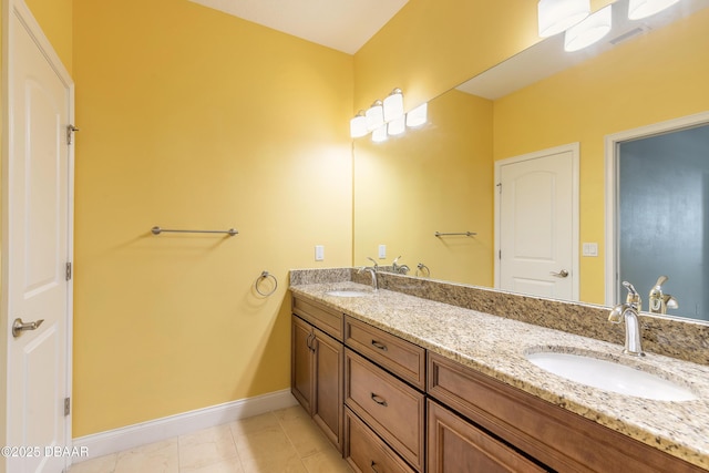 bathroom with tile patterned flooring and vanity