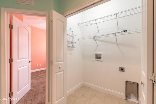 washroom featuring washer hookup, light tile patterned flooring, and electric dryer hookup