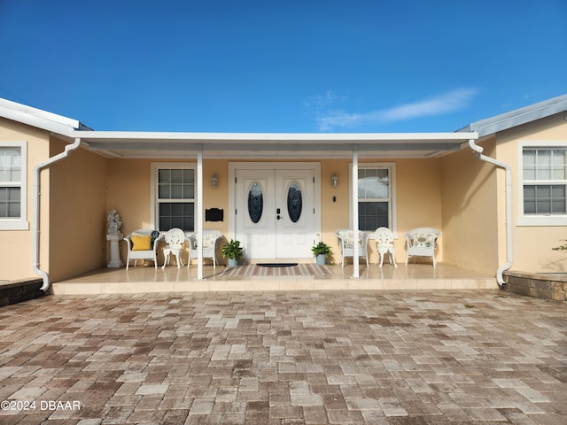 view of exterior entry with covered porch