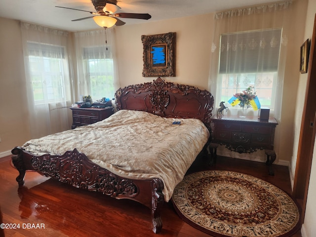 bedroom featuring wood-type flooring, multiple windows, and ceiling fan