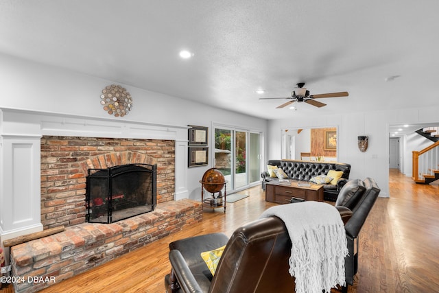 120 Beach St, Ponce Inlet, FL 32127 - living area featuring stairs, wood finished floors, a brick fireplace, a ceiling fan, and recessed lighting