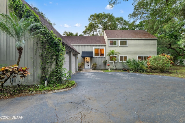 120 Beach St, Ponce Inlet, FL 32127 - view of front of property featuring a garage, asphalt driveway, board and batten siding, and roof with shingles