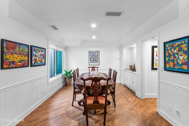 120 Beach St, Ponce Inlet, FL 32127 - dining space featuring light wood-type flooring, recessed lighting, and wainscoting