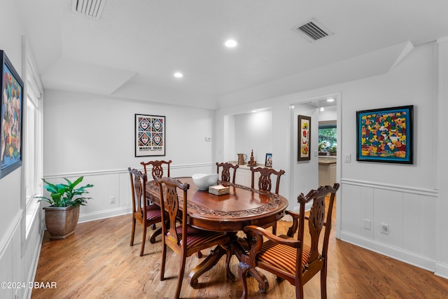 120 Beach St, Ponce Inlet, FL 32127 - dining space featuring a decorative wall, light wood-style floors, recessed lighting, and wainscoting