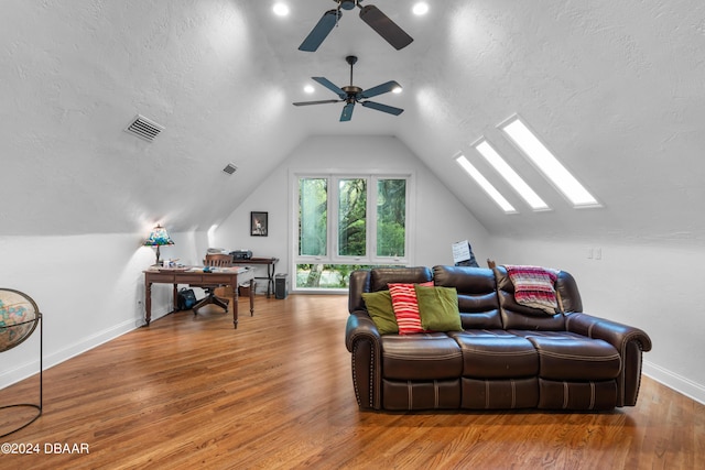 120 Beach St, Ponce Inlet, FL 32127 - living room with lofted ceiling, wood finished floors, a ceiling fan, a textured ceiling, and a skylight