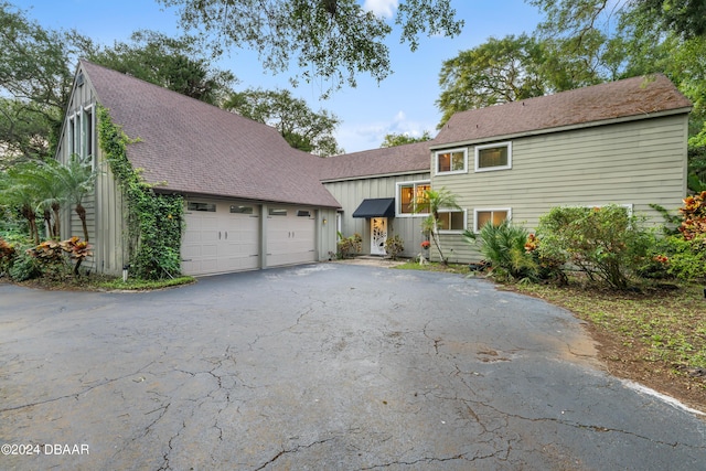 120 Beach St, Ponce Inlet, FL 32127 - view of front of house featuring asphalt driveway, an attached garage, board and batten siding, and roof with shingles