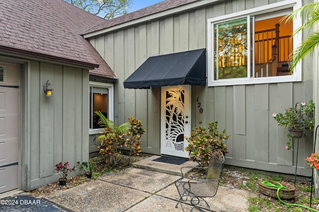 120 Beach St, Ponce Inlet, FL 32127 - view of exterior entry featuring a shingled roof and board and batten siding