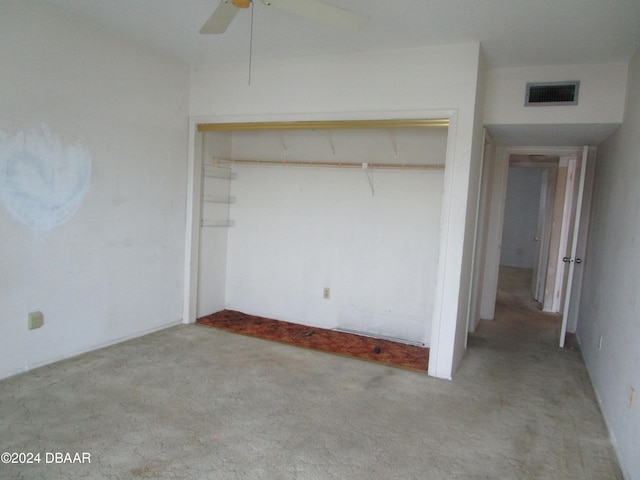 unfurnished bedroom featuring light carpet, a closet, and ceiling fan