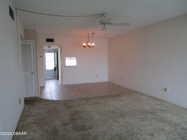 carpeted spare room featuring ceiling fan