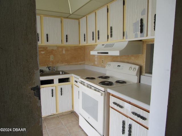 kitchen featuring a drop ceiling, white electric range, sink, and light tile patterned floors