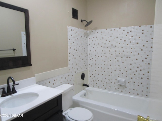 full bathroom featuring vanity, toilet, tub / shower combination, and tile walls