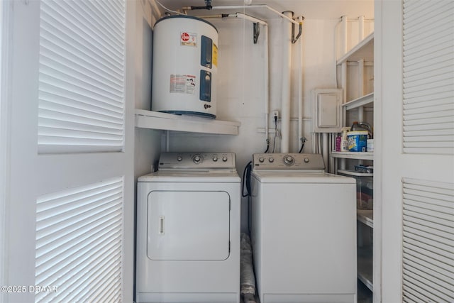 clothes washing area with laundry area, washing machine and dryer, and electric water heater