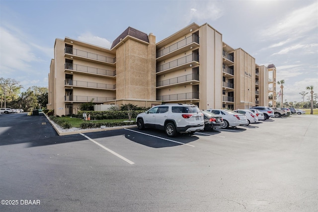 view of building exterior with uncovered parking