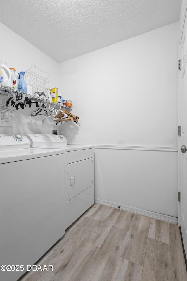 133 Brasswood Ct, Daytona Beach, FL 32117 - washroom featuring laundry area, a textured ceiling, separate washer and dryer, and light wood-type flooring