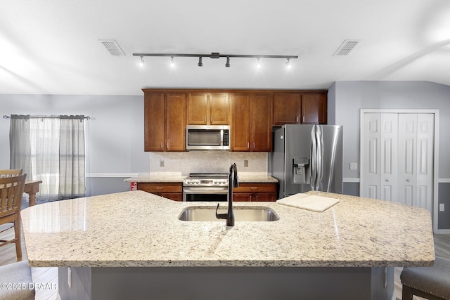 133 Brasswood Ct, Daytona Beach, FL 32117 - kitchen with rail lighting, stainless steel appliances, an island with sink, and a sink