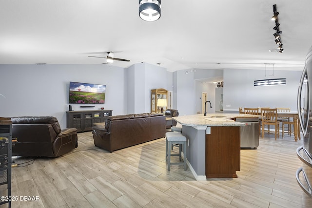 133 Brasswood Ct, Daytona Beach, FL 32117 - kitchen featuring dishwasher, vaulted ceiling, light wood-style flooring, and an island with sink