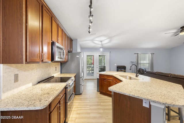 133 Brasswood Ct, Daytona Beach, FL 32117 - kitchen with a breakfast bar, a sink, open floor plan, backsplash, and stainless steel appliances