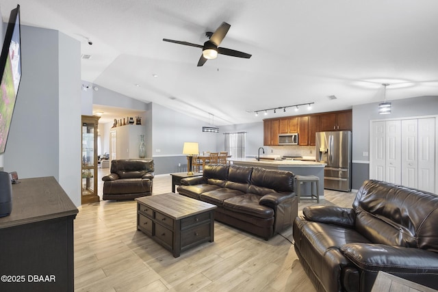 133 Brasswood Ct, Daytona Beach, FL 32117 - living room with track lighting, vaulted ceiling, light wood-style flooring, and ceiling fan