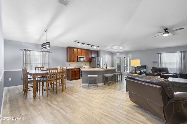 133 Brasswood Ct, Daytona Beach, FL 32117 - living area with a ceiling fan, light wood-style flooring, baseboards, visible vents, and track lighting
