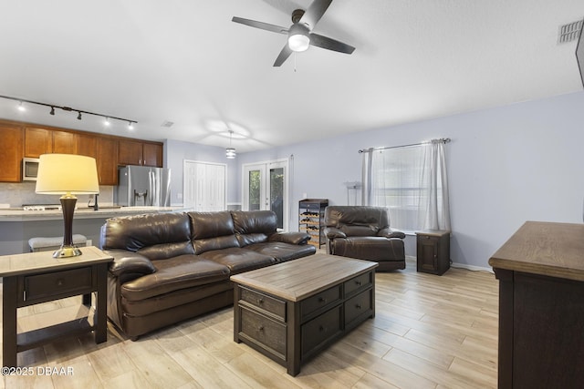 133 Brasswood Ct, Daytona Beach, FL 32117 - living area featuring track lighting, visible vents, ceiling fan, light wood-style flooring, and baseboards