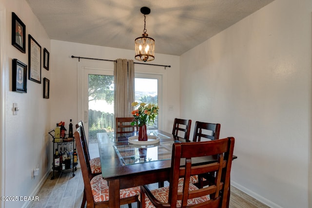 dining space featuring a textured ceiling and a chandelier