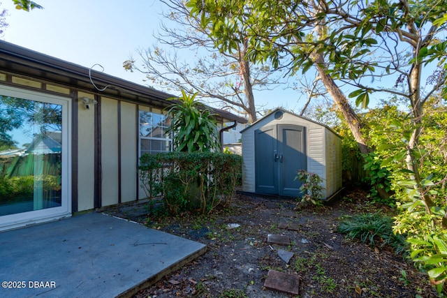 exterior space featuring a shed and a patio area