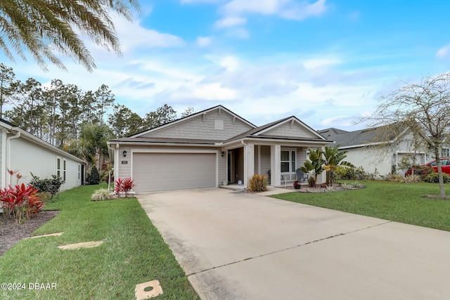 single story home with concrete driveway, a front yard, covered porch, and a garage
