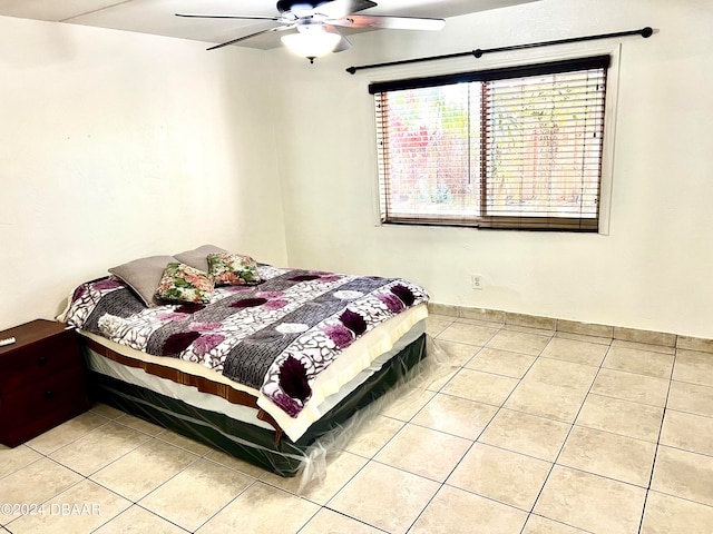 tiled bedroom with ceiling fan