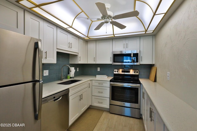 2625 S Atlantic Ave Unit 10Nw, Daytona Beach Shores, FL 32118 - kitchen with stainless steel appliances, light countertops, light wood finished floors, tasteful backsplash, and ceiling fan