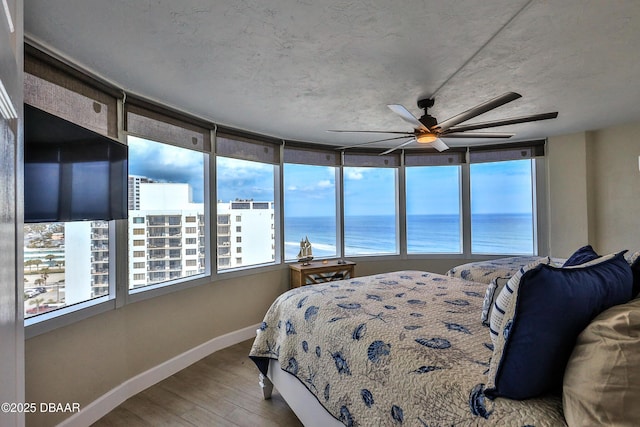 2625 S Atlantic Ave Unit 10Nw, Daytona Beach Shores, FL 32118 - bedroom with wood finished floors, a water view, and a ceiling fan