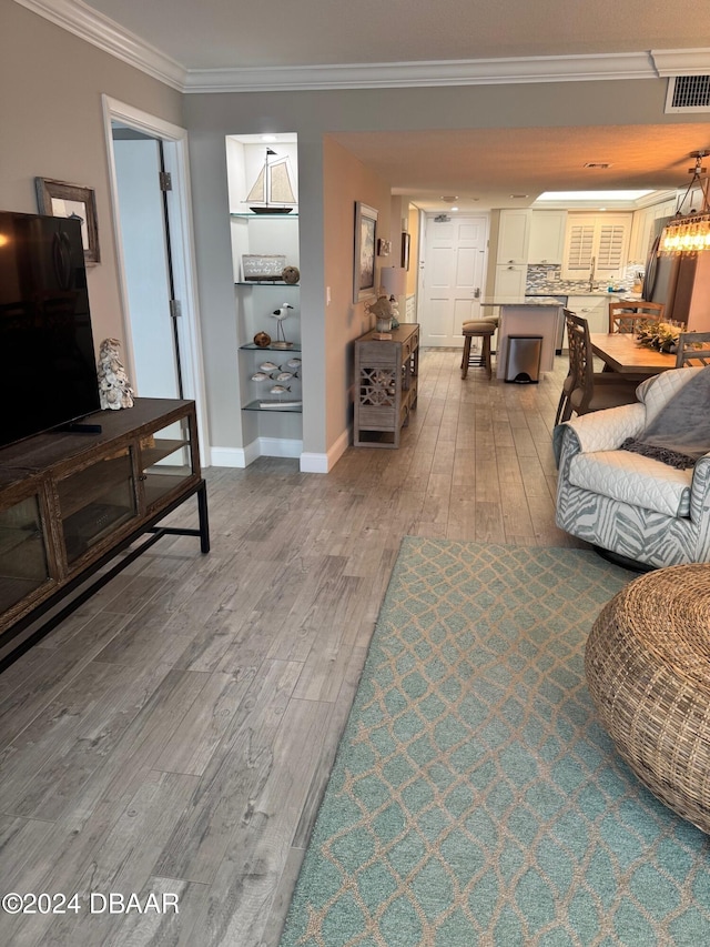 living room featuring hardwood / wood-style floors and ornamental molding