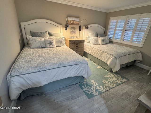 bedroom with crown molding and wood-type flooring