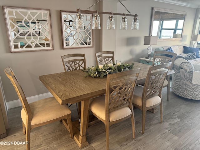 dining room featuring hardwood / wood-style floors and crown molding