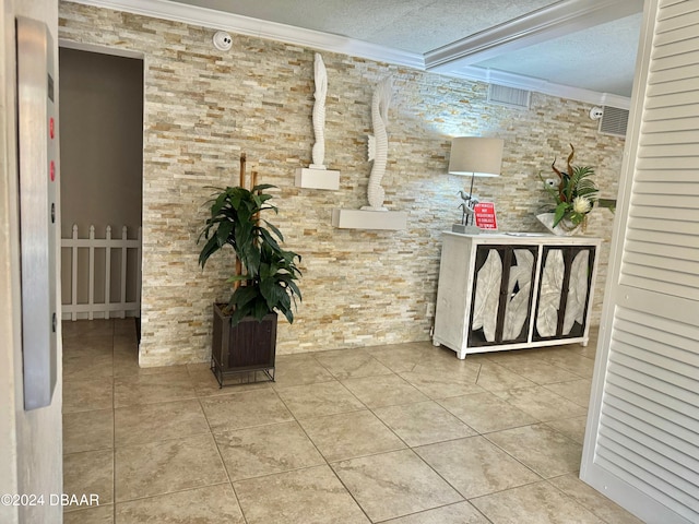 hall featuring crown molding, light tile patterned floors, and a textured ceiling