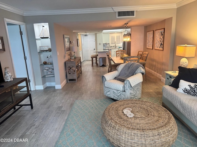 living room featuring dark hardwood / wood-style floors and ornamental molding