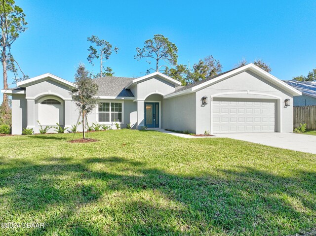 single story home featuring a garage and a front lawn