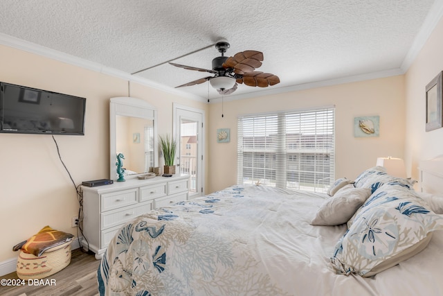 bedroom featuring a textured ceiling, light wood-type flooring, ceiling fan, and crown molding