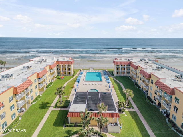 drone / aerial view with a water view and a view of the beach